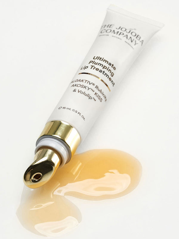 The Jojoba Company Ultimate Plumping Lip Treatment tube with a smear of the gel