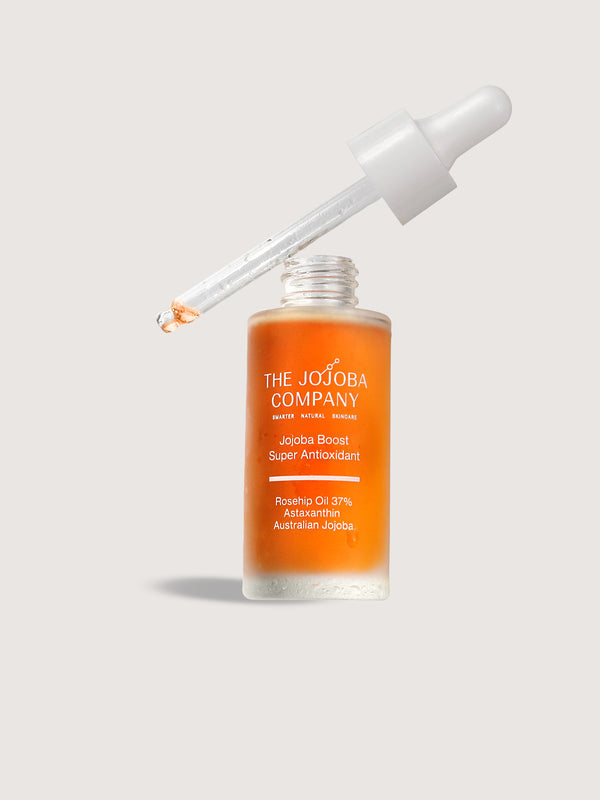 The Jojoba Company Jojoba Boost Super Antioxidant dropper bottle with orange serum