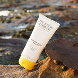 The Jojoba Company Australian Jojoba Aqua Gel tube on a rock by the ocean