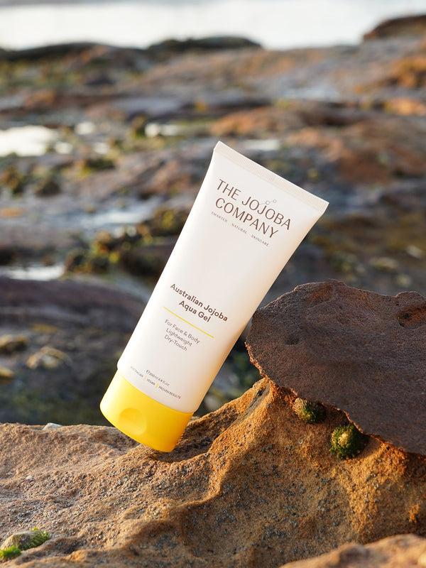 The Jojoba Company Australian Jojoba Aqua Gel tube on a rock by the ocean