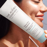 Woman holding a tube of The Jojoba Company Citrus Gel Cleanser