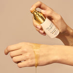 Applying The Jojoba Company Pigmentation Oil to the wrist
