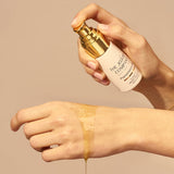Applying The Jojoba Company Pigmentation Oil to the wrist