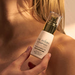 Holding a bottle of The Jojoba Company Pigmentation Oil