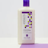 Andalou Naturals Full Volume Lavender & Biotin Conditioner styled on a lavender background