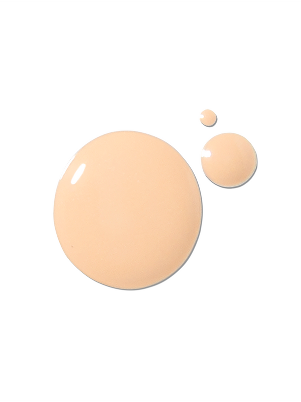 A pale peach-beige foundation swatch forms one large glossy circle and two smaller drops on white. This image shows the liquid colour and texture of 100% Pure 2nd Skin Serum Foundation.