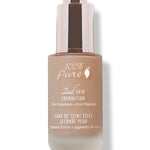 A closed frosted glass bottle of tan 100% Pure 2nd Skin Serum Foundation stands upright with white lettering and a tall reflective rose-gold dropper cap.