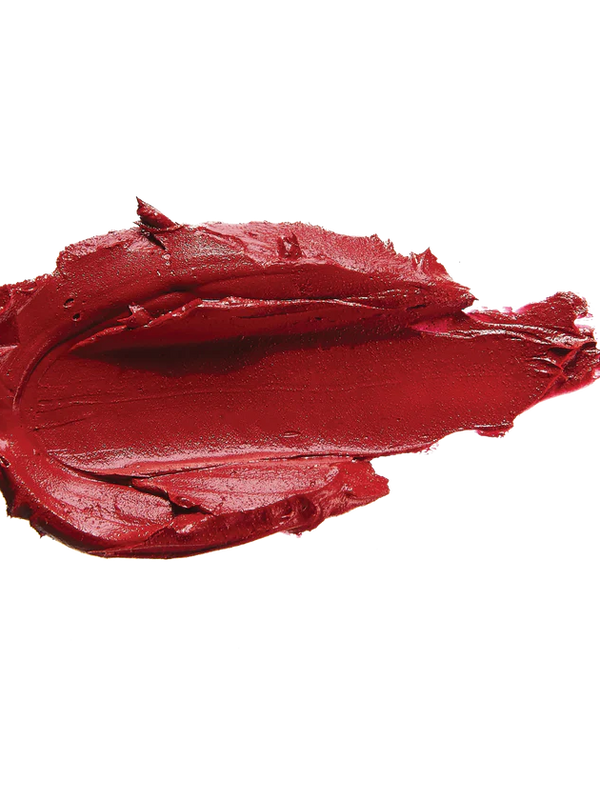 A thick smear of deep warm red Blood Orange matte lipstick on white, with a smooth centre and raised, creamy ridges around the edges.