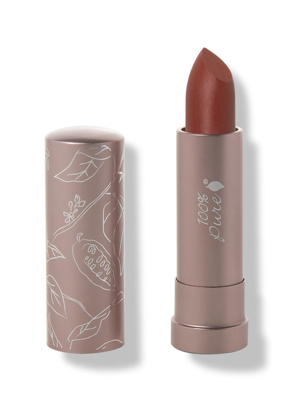 100% Pure Cacti matte lipstick with a slanted rust brown tip extended from a taupe tube; its matching cap stands beside it with white botanical line drawings.