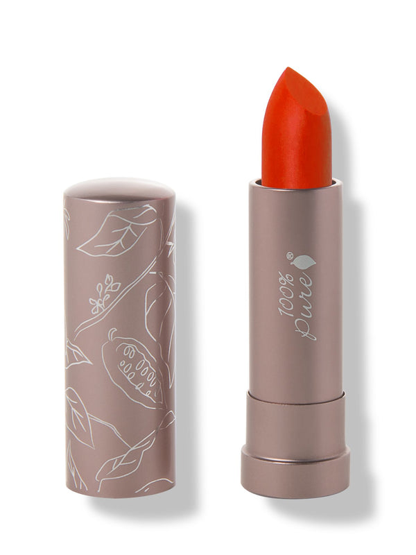 100% Pure Cactus Bloom matte lipstick with a slanted vivid orange red tip extended from a taupe tube; its matching cap stands beside it with white botanical line drawings.