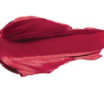 A thick smear of deep crimson red Currant matte lipstick on white, with a smooth centre and raised, creamy ridges around the edges.