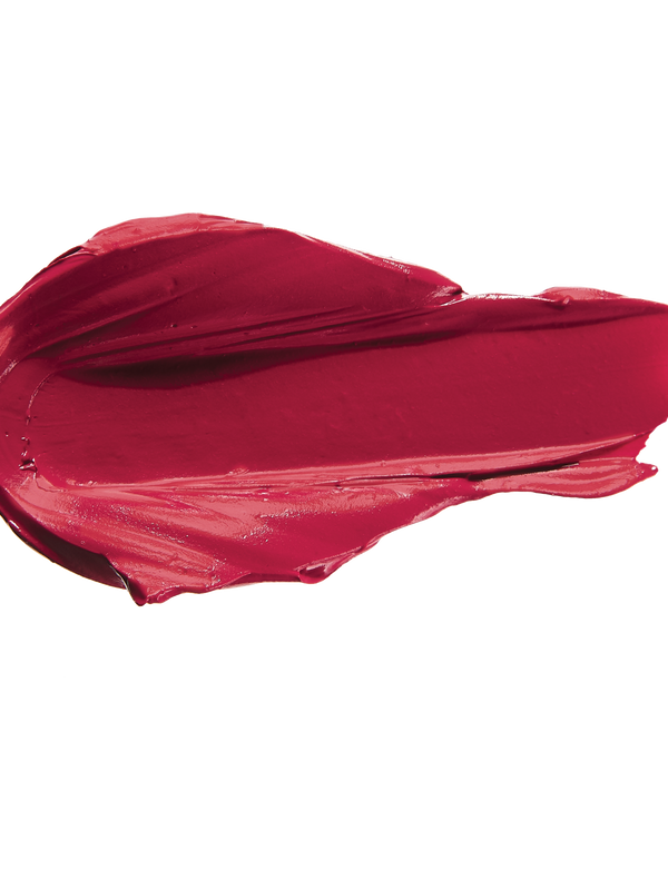 A thick smear of deep crimson red Currant matte lipstick on white, with a smooth centre and raised, creamy ridges around the edges.