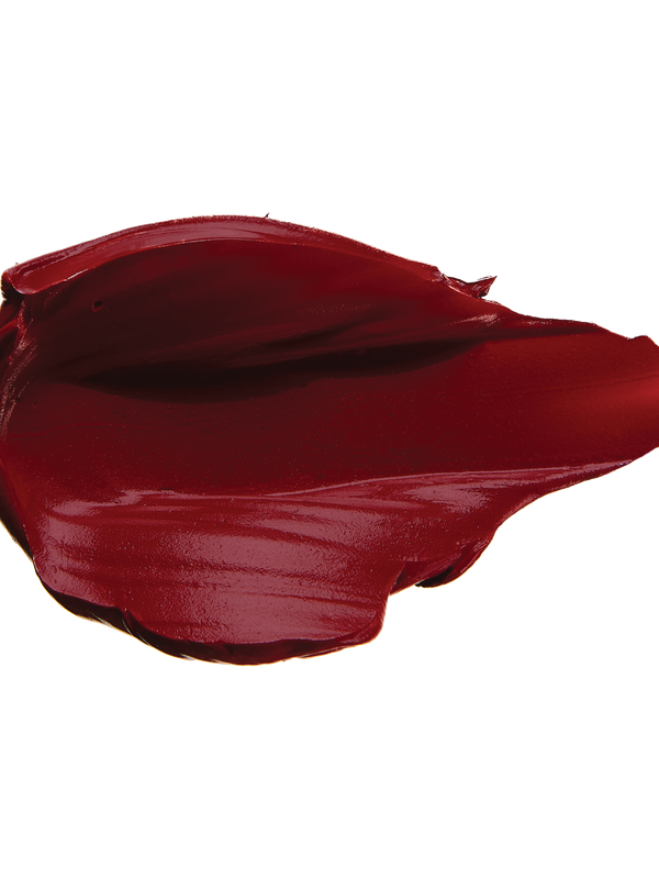 A thick smear of dark burgundy red Desert Rose matte lipstick on white, with a smooth centre and raised, creamy ridges around the edges.