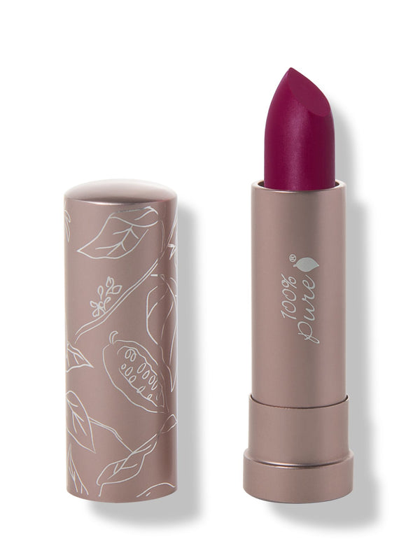 100% Pure Hyacinthus matte lipstick with a slanted deep plum purple tip extended from a taupe tube; its matching cap stands beside it with white botanical line drawings.