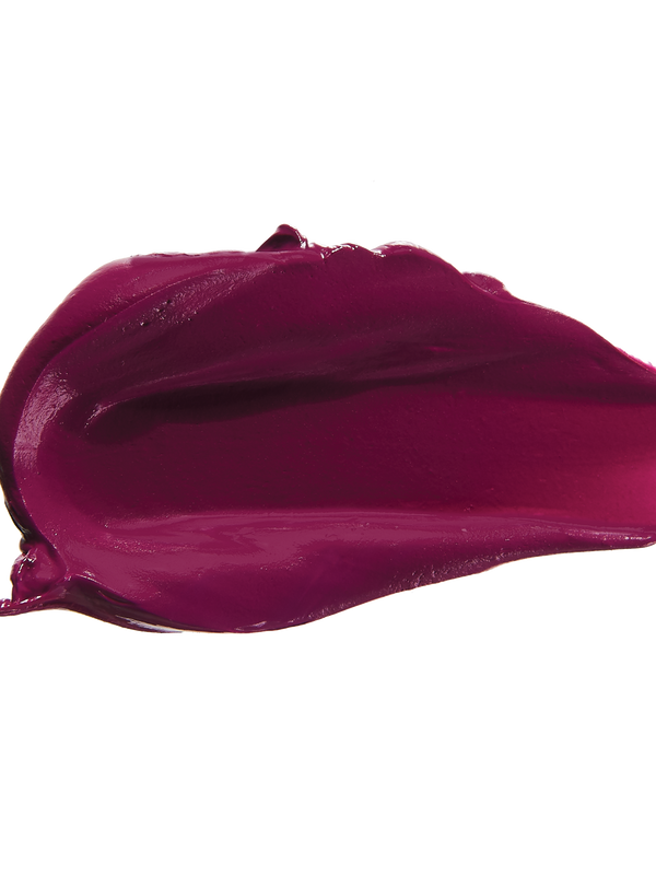 A thick smear of deep plum purple Hyacinthus matte lipstick on white, with a smooth centre and raised, creamy ridges around the edges.