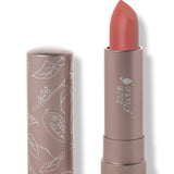 100% Pure Mirage matte lipstick with a slanted muted coral pink tip extended from a taupe tube; its matching cap stands beside it with white botanical line drawings.