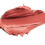 A thick smear of muted coral pink Mirage matte lipstick on white, with a smooth centre and raised, creamy ridges around the edges.