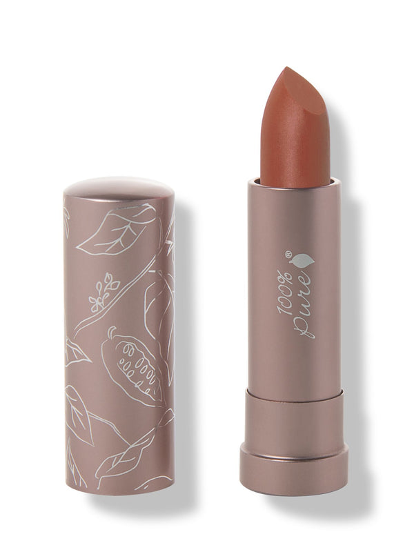 100% Pure Mojave matte lipstick with a slanted warm orange brown tip extended from a taupe tube; its matching cap stands beside it with white botanical line drawings.