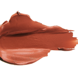A thick smear of warm orange brown Mojave matte lipstick on white, with a smooth centre and raised, creamy ridges around the edges.