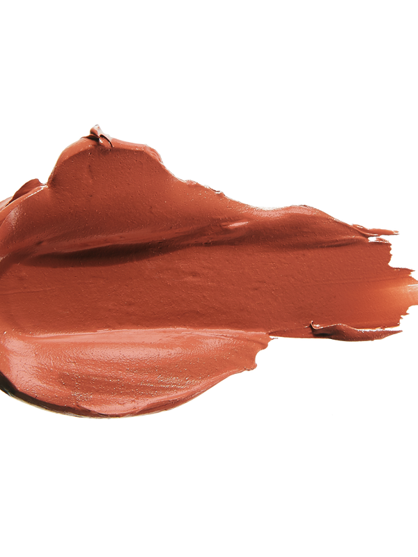 A thick smear of warm orange brown Mojave matte lipstick on white, with a smooth centre and raised, creamy ridges around the edges.