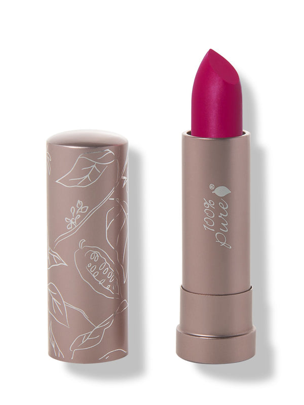 100% Pure Marrakesh matte lipstick with a slanted vivid fuchsia pink tip extended from a taupe tube; its matching cap stands beside it with white botanical line drawings.
