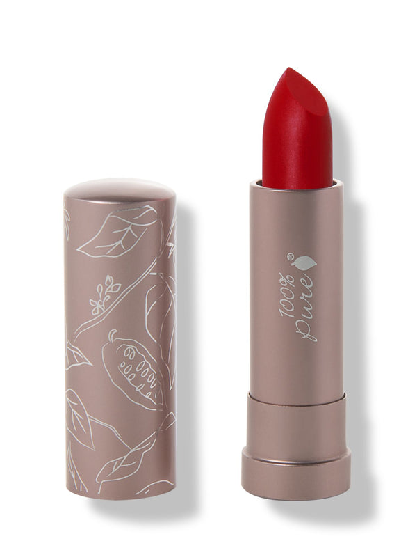 100% Pure Nopal matte lipstick with a slanted rich cherry red tip extended from a taupe tube; its matching cap stands beside it with white botanical line drawings.