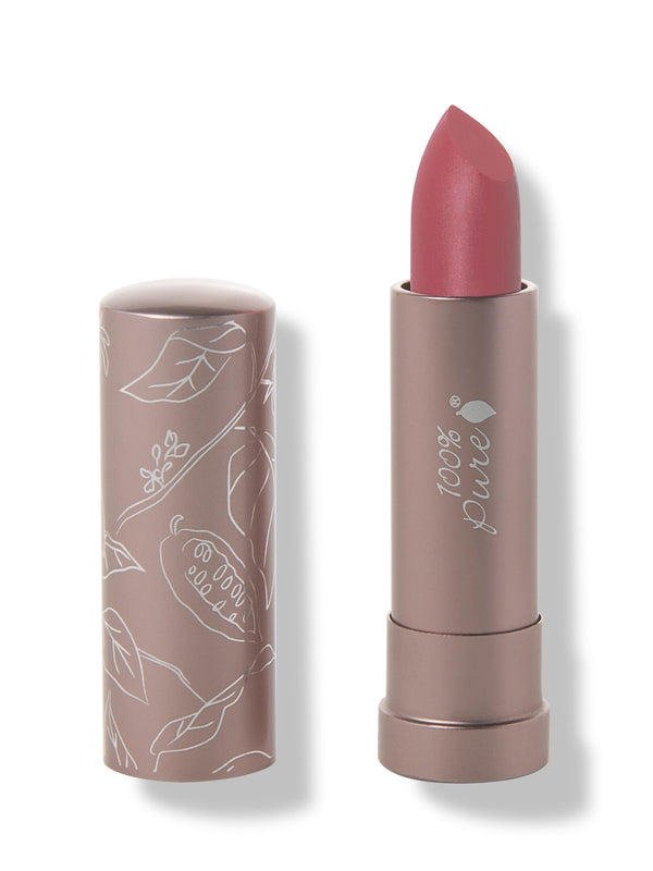 100% Pure Plume Pink matte lipstick with a slanted dusty rose pink tip extended from a taupe tube; its matching cap stands beside it with white botanical line drawings.
