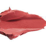 A thick smear of dusty rose pink Plume Pink matte lipstick on white, with a smooth centre and raised, creamy ridges around the edges.
