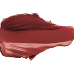 A thick smear of brownish brick red Savanna matte lipstick on white, with a smooth centre and raised, creamy ridges around the edges.