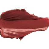 A thick smear of brownish brick red Savanna matte lipstick on white, with a smooth centre and raised, creamy ridges around the edges.