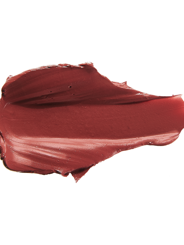 A thick smear of brownish brick red Savanna matte lipstick on white, with a smooth centre and raised, creamy ridges around the edges.