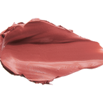 A thick smear of muted brick rose Sahara matte lipstick on white, with a smooth centre and raised, creamy ridges around the edges.
