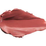 A thick smear of muted brick rose Sahara matte lipstick on white, with a smooth centre and raised, creamy ridges around the edges.