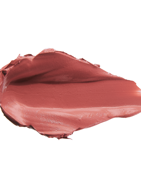 A thick smear of muted brick rose Sahara matte lipstick on white, with a smooth centre and raised, creamy ridges around the edges.