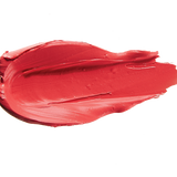A thick smear of bright coral red Strawberry Cactus matte lipstick on white, with a smooth centre and raised, creamy ridges around the edges.
