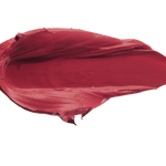A thick smear of deep berry red Winecup matte lipstick on white, with a smooth centre and raised, creamy ridges around the edges.