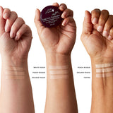 Three forearms with light, medium and dark skin each show three beige to tan concealer stripes. Labels identify White Peach, Peach Bisque, Golden Peach and Toffee. The middle hand holds a Long Last Concealer pot with a burgundy lid.