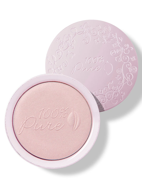 An open pale pink compact of Moonstone Glow luminiser, showing pearly pink powder embossed with the 100% Pure logo and a matching patterned lid behind it.