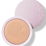 An open pale pink compact of Copper Gold luminiser, showing warm golden powder embossed with the 100% Pure logo and a matching patterned lid behind it.