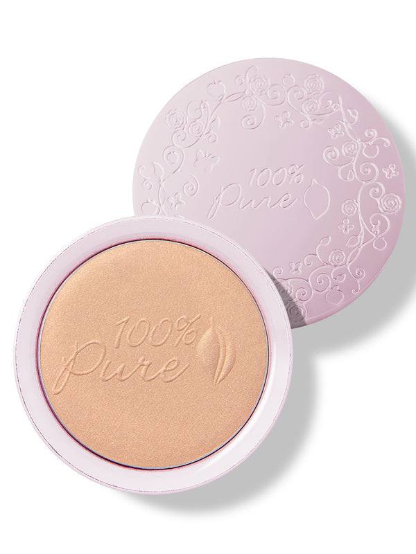 An open pale pink compact of Copper Gold luminiser, showing warm golden powder embossed with the 100% Pure logo and a matching patterned lid behind it.
