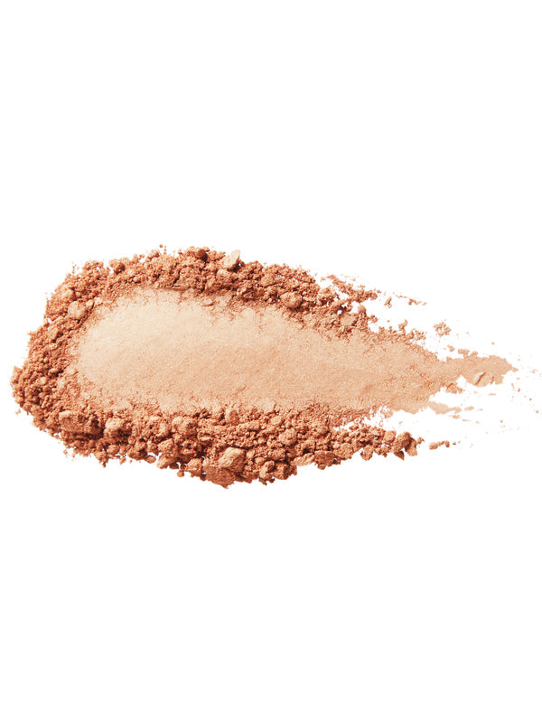 A swatch of Copper Gold luminiser with a pale golden, shimmering centre surrounded by loose copper coloured powder on white.