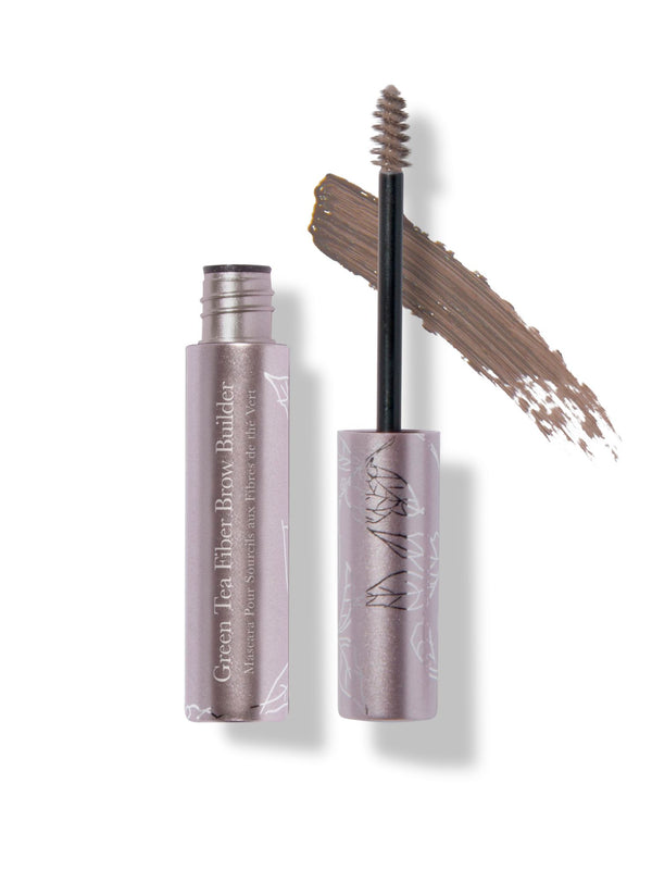 Soft Brown Green Tea Fibre Brow Builder: an open metallic pink tube and a small spiral brush in front of a soft brown brushstroke. Fine white botanical drawings decorate the wand cap.