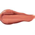 Butterchew 100% Pure Lip Caramel swatch: thick, glossy warm rose-brown liquid lipstick spread into an elongated smear, with raised ridges and a tapering streak at one end.