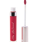 100% Pure Lip Caramel in Cherry Cordial: an open clear tube of bright berry-red liquid lipstick beside a white applicator wand with a reflective silver-pink cap and a tip coated in the same shade.