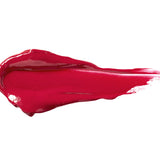 Cherry Cordial 100% Pure Lip Caramel swatch: thick, glossy bright berry-red liquid lipstick spread into an elongated smear, with raised ridges and a tapering streak at one end.