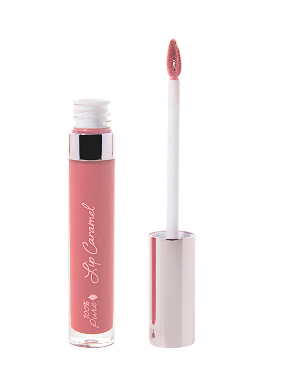 100% Pure Lip Caramel in Ganache: an open clear tube of rosy pink liquid lipstick beside a white applicator wand with a reflective silver-pink cap and a tip coated in the same shade.