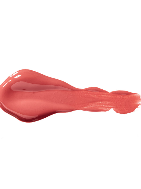 Ganache 100% Pure Lip Caramel swatch: thick, glossy rosy pink liquid lipstick spread into an elongated smear, with raised ridges and a tapering streak at one end.