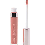 100% Pure Lip Caramel in Rum Nougat: an open clear tube of dusty peach-rose liquid lipstick beside a white applicator wand with a reflective silver-pink cap and a tip coated in the same shade.