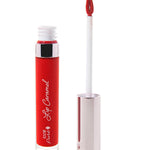100% Pure Lip Caramel in Red Velvet: an open clear tube of rich red liquid lipstick beside a white applicator wand with a reflective silver-pink cap and a tip coated in the same shade.