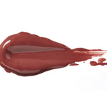 Truffle 100% Pure Lip Caramel swatch: thick, glossy deep mauve-brown liquid lipstick spread into an elongated smear, with raised ridges and a tapering streak at one end.
